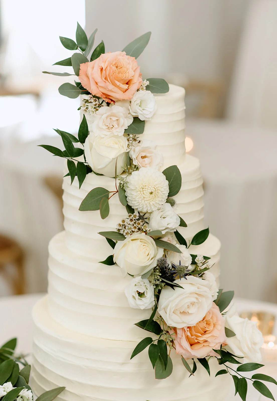 Four tier wedding cake with flowers